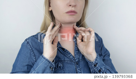 Woman touching sore neck and thyroid gland area, suffering from pain, goiter, throat infection or Venus wrinkles. Medical healthcare and endocrinology concept. Woman touching sore neck and thyroid gland area, suffering from pain, goiter, throat infection or Venus wrinkles. Medical healthcare and endocrinology concept. 139793368