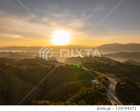 Aerial view of Twisting Mountain Road Under a Radiant Nan Sunset Aerial view of Twisting Mountain Road Under a Radiant Nan Sunset 139794071