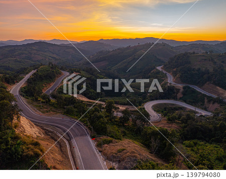 Aerial view of Twisting Mountain Road Under a Radiant Nan Sunset Aerial view of Twisting Mountain Road Under a Radiant Nan Sunset 139794080