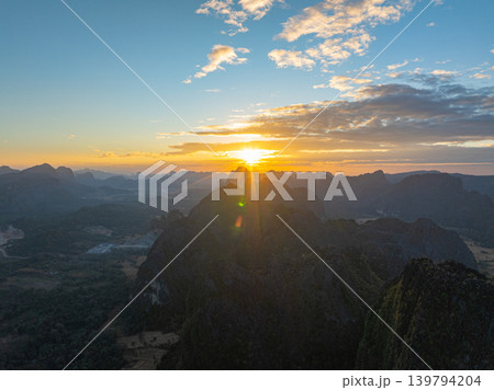 Aerial Over Majestic Mountains Beneath a Colorful Sky Aerial Over Majestic Mountains Beneath a Colorful Sky 139794204
