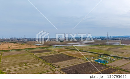 April 30 2026 Nangu Shin Rifu countryside with farmland powerlines and urban skyline 139795623