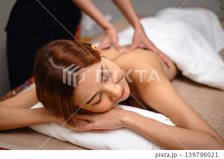 Relaxed woman lies on massage table 139796021