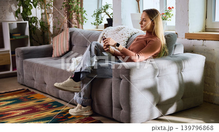 Woman using mobile banking with card and smartphone at home. 139796868