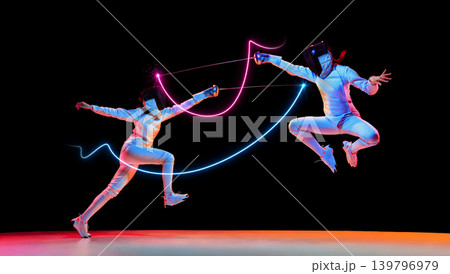Intense fencing action with neon light trails and dramatic jump movement. 139796979