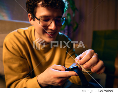 Close up man removing protective film from smartwatch after unboxing Close up man removing protective film from smartwatch after unboxing 139796991