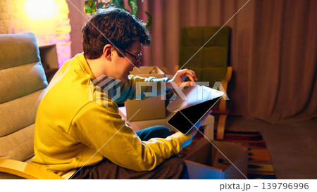man holding tablet and unboxing new device at home enjoying technology purchase man holding tablet and unboxing new device at home enjoying technology purchase 139796996