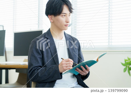 カウンセリング　話を聞きながらメモをとる若い日本人医師 139799090