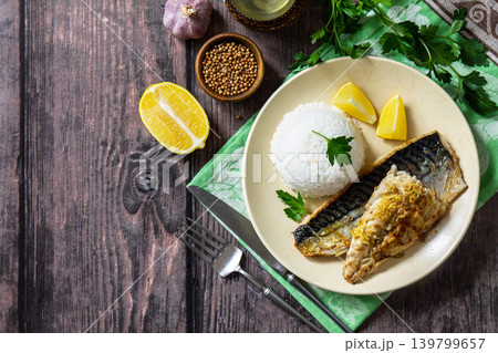 Grilled baked mackerel in a ginger mustard honey sauce, served with rice on a rustic table. View from above. Copy space. Grilled baked mackerel in a ginger mustard honey sauce, served with rice on a rustic table. View from above. Copy space. 139799657