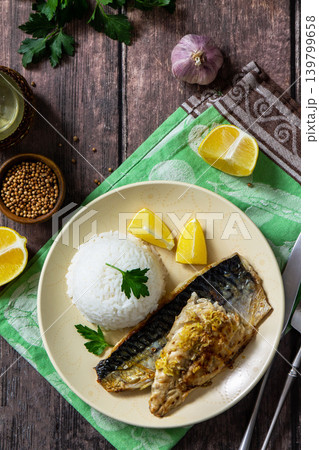 Grilled baked mackerel in a ginger mustard honey sauce, served with rice on a rustic table. View from above. Grilled baked mackerel in a ginger mustard honey sauce, served with rice on a rustic table. View from above. 139799658