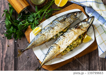 Grilled baked mackerel in ginger mustard honey sauce stuffed with vegetables and cheese on a rustic tabletop. View from above. 139799663