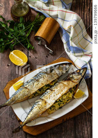 Grilled baked mackerel in ginger mustard honey sauce stuffed with vegetables and cheese on a rustic tabletop. 139799666