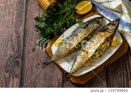 Grilled baked mackerel in ginger mustard honey sauce stuffed with vegetables and cheese on a rustic tabletop. Copy space. 139799668