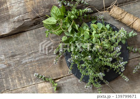 Fresh green mint melissa with flowers on a rustic wooden table. Organic natural plant leaf. View from above. Copy space. Fresh green mint melissa with flowers on a rustic wooden table. Organic natural plant leaf. View from above. Copy space. 139799671