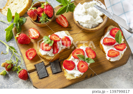 Bruschetta with ricotta and strawberry on a stone tabletop. Berries toast summer breakfast, healthy food. 139799817