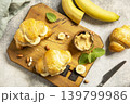 French pastry, freshly baked croissants with peanut butter and banana on a grey stone background. Healthy food dessert concept. View from above. 139799986