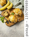 French pastry, freshly baked croissants with peanut butter and banana on a grey stone background. Healthy food dessert concept. View from above. Copy space. 139799989