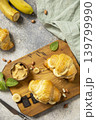 French pastry, freshly baked croissants with peanut butter and banana on a grey stone background. Healthy food dessert concept. View from above. 139799990