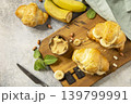 French pastry, freshly baked croissants with peanut butter and banana on a grey stone background. Healthy food dessert concept. View from above. Copy space. 139799991
