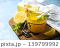 Sweet melon and citrus jam, homemade jelly preserves in small glass jar with fresh melon slices on a blue stone tabletop. Homemade preserve. Copy space. 139799992