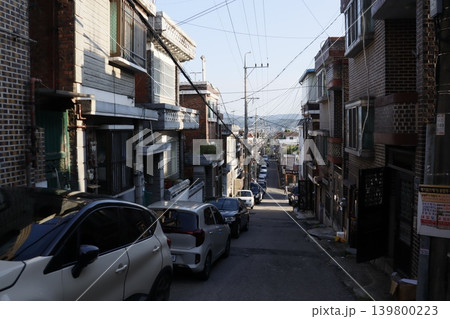Narrow Urban Street with Residential Buildings and Parked Cars Narrow Urban Street with Residential Buildings and Parked Cars 139800223