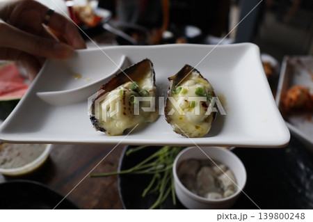 Oysters with Cream and Scallions on White Plate 139800248