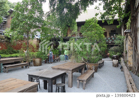 Courtyard Garden with Wooden Furniture and Greenery Courtyard Garden with Wooden Furniture and Greenery 139800423