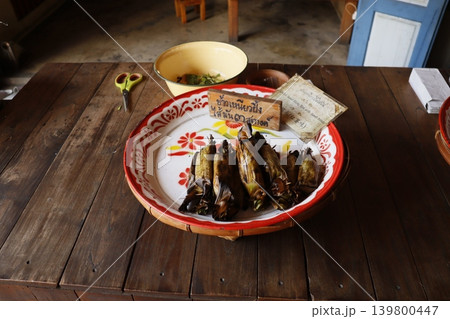 Traditional Thai Wrapped Food on Wooden Table 139800447