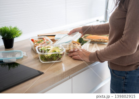 Woman Preparing Healthy Weekly Meal Prep Containers Woman Preparing Healthy Weekly Meal Prep Containers 139802915