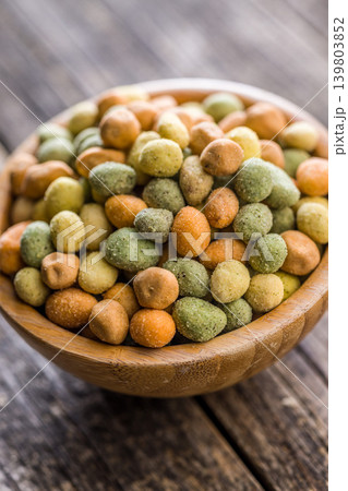 Rustic Wooden Bowl Filled With Mixed Coated Peanuts and Crunchy Wasabi Peas Snack Rustic Wooden Bowl Filled With Mixed Coated Peanuts and Crunchy Wasabi Peas Snack 139803852