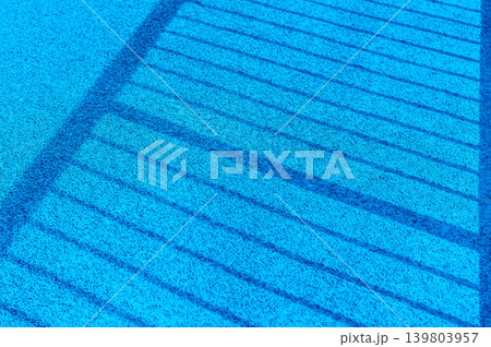 Vibrant Blue Playground Floor Background with Graphic Shadow Lines and Copy Space for Modern Design Vibrant Blue Playground Floor Background with Graphic Shadow Lines and Copy Space for Modern Design 139803957