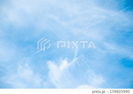 Beautiful Blue Sky Background with Airplane Contrail Line, Vapor Trail and White Fluffy Clouds Beautiful Blue Sky Background with Airplane Contrail Line, Vapor Trail and White Fluffy Clouds 139803990