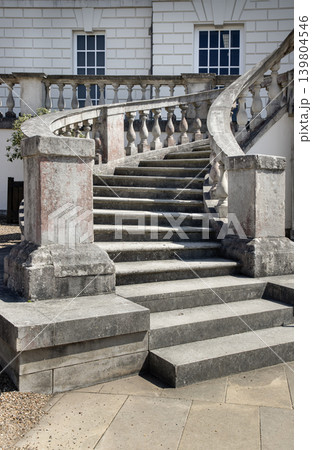 Defying the prevailing Tudor and Gothic trends of its time, the Palladian-inspired horseshoe staircase in front of the Queen House ascends gracefully toward a classical terrace. Its weathered stone Defying the prevailing Tudor and Gothic trends of its time, the Palladian-inspired horseshoe staircase in front of the Queen House ascends gracefully toward a classical terrace. Its weathered stone 139804546