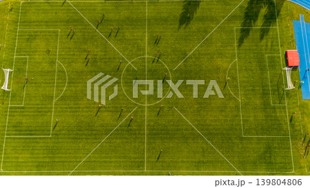 Topdown perspective of soccer match. An aerial shot capturing shadows and structures during soccer game 139804806