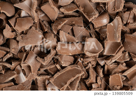 Macro texture of broken milk chocolate pieces pile background Macro texture of broken milk chocolate pieces pile background 139805509