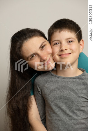 Portrait of a happy mother and her school-age son smiling at the camera. Portrait of a happy mother and her school-age son smiling at the camera. 139805512