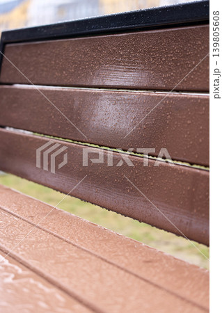 High-resolution macro of water surface tension and droplets on a textured synthetic wood material 139805608