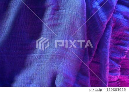 Soft blue fabric draped on a flat surface showing texture and details in natural light during daytime Soft blue fabric draped on a flat surface showing texture and details in natural light during daytime 139805636
