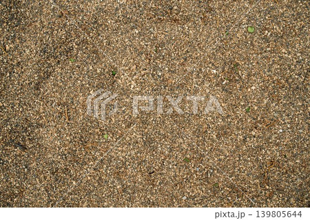 Flat lay of granular sandy soil ground surface, ideal for natural wallpaper, textured screensavers 139805644