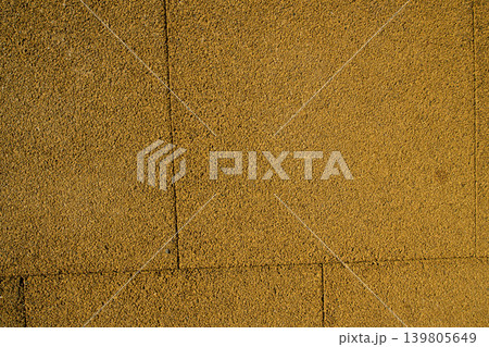 Safety floor design featuring a clean yellow-brown recycled rubber tile layout, suitable for urban parks Safety floor design featuring a clean yellow-brown recycled rubber tile layout, suitable for urban parks 139805649