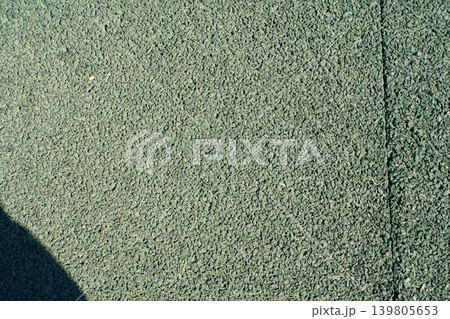 Granular green rubber crumb surface texture close up Granular green rubber crumb surface texture close up 139805653