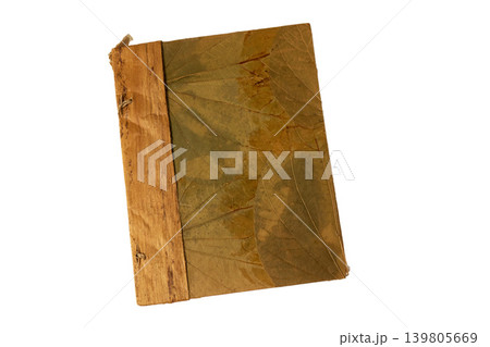 Aged journal display. Rustic green covered journal featuring faded markings and aged paper edges for artistic setting Aged journal display. Rustic green covered journal featuring faded markings and aged paper edges for artistic setting 139805669