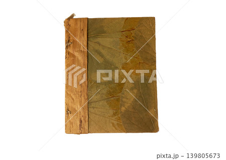 Worn binding on white background. Top down view of weathered book cover against clean white backdrop with subtle patina Worn binding on white background. Top down view of weathered book cover against clean white backdrop with subtle patina 139805673