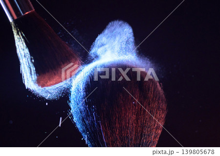 Brush powder explosion forms dense cloud, closeup of plume and tiny particles with red and blue rim lighting editorial test shot capturing dramatic airborne dust, high Brush powder explosion forms dense cloud, closeup of plume and tiny particles with red and blue rim lighting editorial test shot capturing dramatic airborne dust, high 139805678
