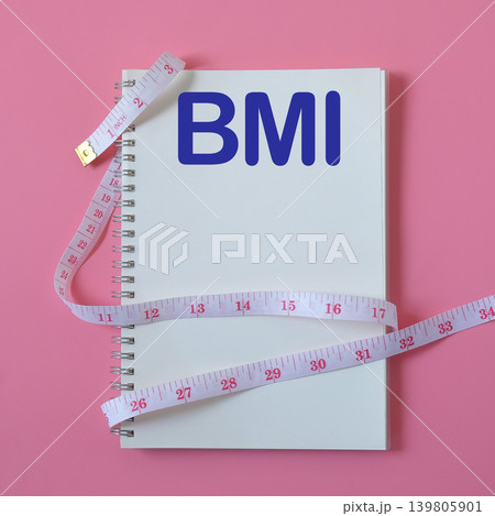BMI text write on book note with measuring tape ,pen on background. 139805901