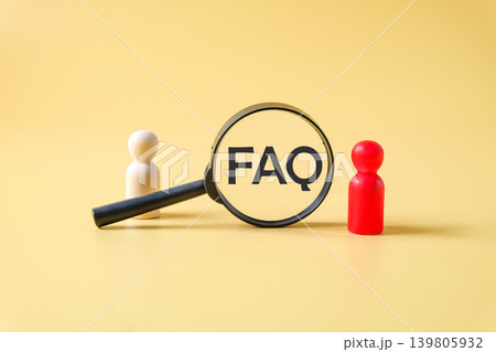 Text FAQ in magnifying glasses with wooden toy. 139805932