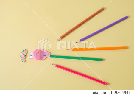Color pencils go straight to sharpener on background. Color pencils go straight to sharpener on background. 139805941