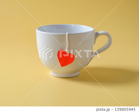 Coffee cup with red heart on color background. Coffee cup with red heart on color background. 139805945