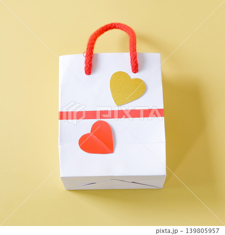 Duo hearts on Empty shopping bag, Front view on background. Duo hearts on Empty shopping bag, Front view on background. 139805957