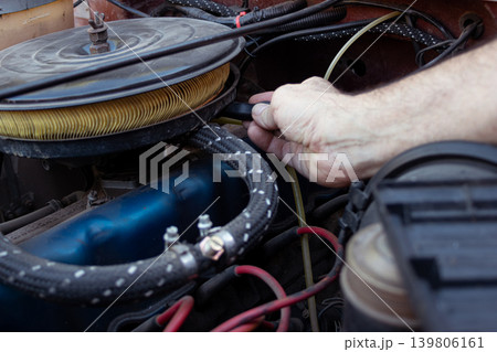 Mechanic's hand working on vintage car engine repair Mechanic's hand working on vintage car engine repair 139806161
