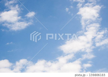 Blue sky background with white fluffy cumulus and stratocumulus clouds on a clear day, offering a feeling of freedom, space, and a bright future Blue sky background with white fluffy cumulus and stratocumulus clouds on a clear day, offering a feeling of freedom, space, and a bright future 139806183